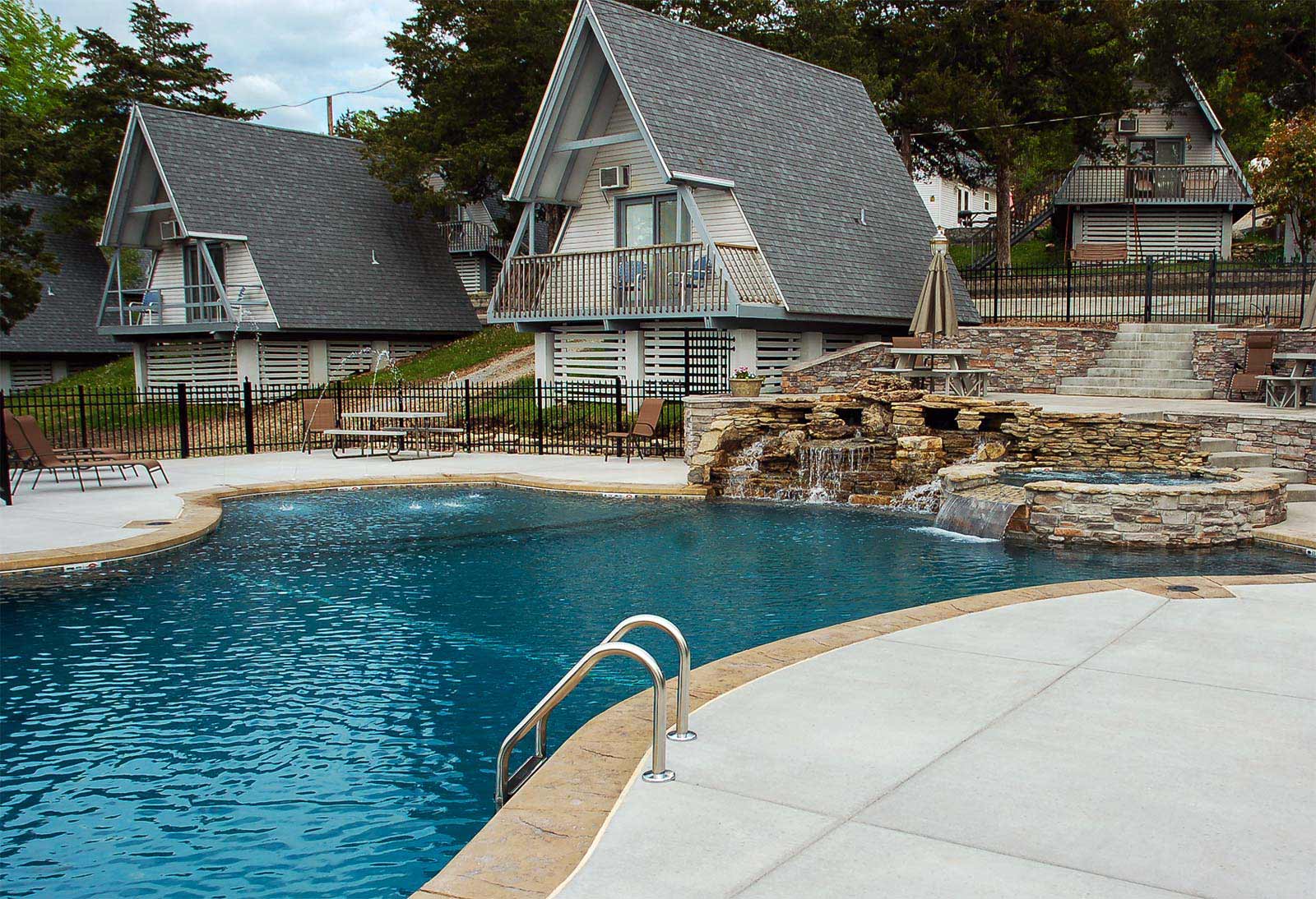 Swimming pool, 9ft hot tub, tanning shelf, vanishing edge and deck jets at Alpine Lodge Resort, Branson, Missouri.